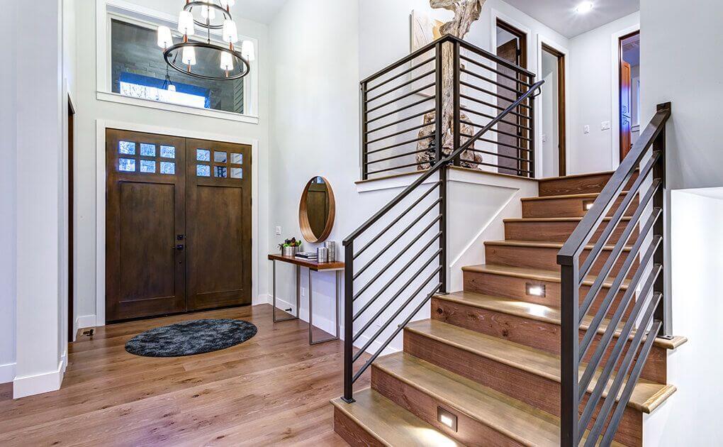 House entryway with beautiful hardwood floors and metal baluster
